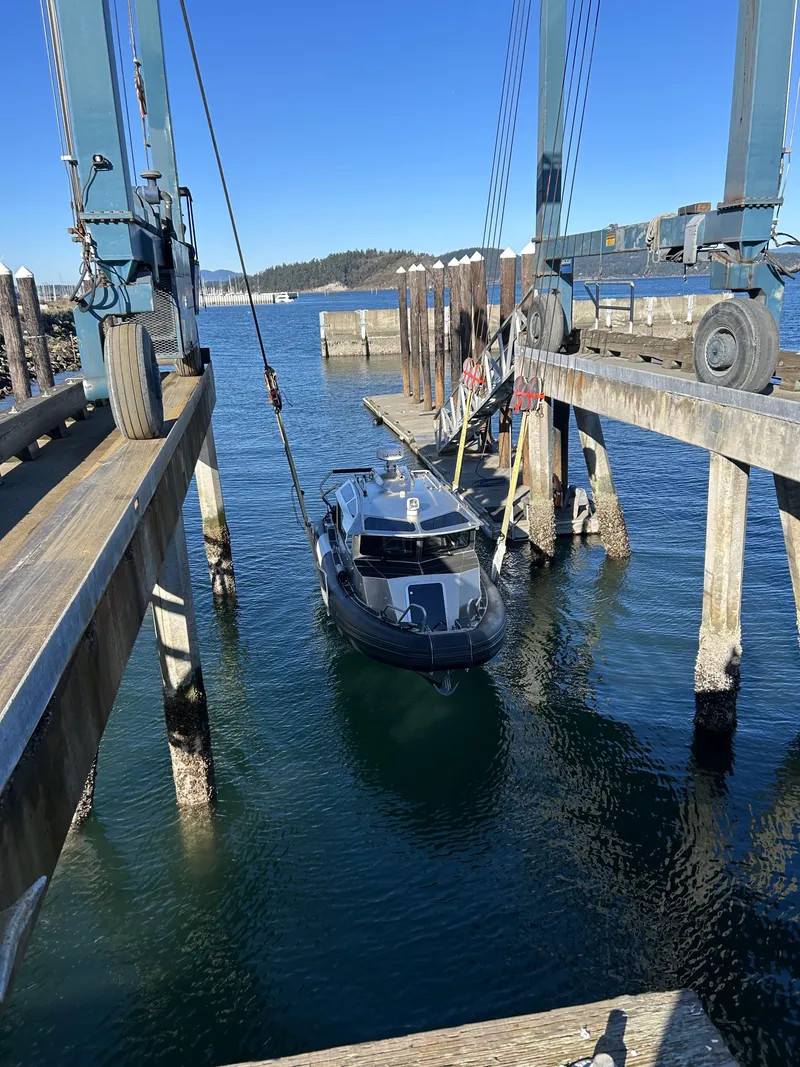 Slide: The Image of 2021 Life Proof 25 Full Cabin boat being lifted at a dockside facility. - 25