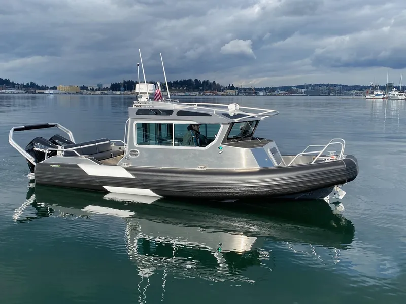 Slide: The Image of 2021 Life Proof 25 Full Cabin boat on calm water under cloudy skies. - 27