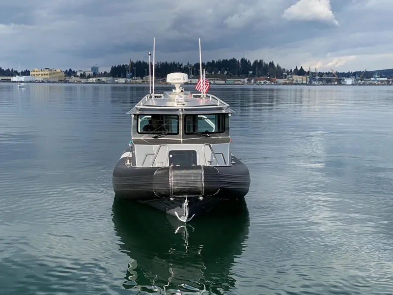 Slide: The Image of 2021 Life Proof 25 Full Cabin boat on calm water with cloudy sky backdrop. - 30