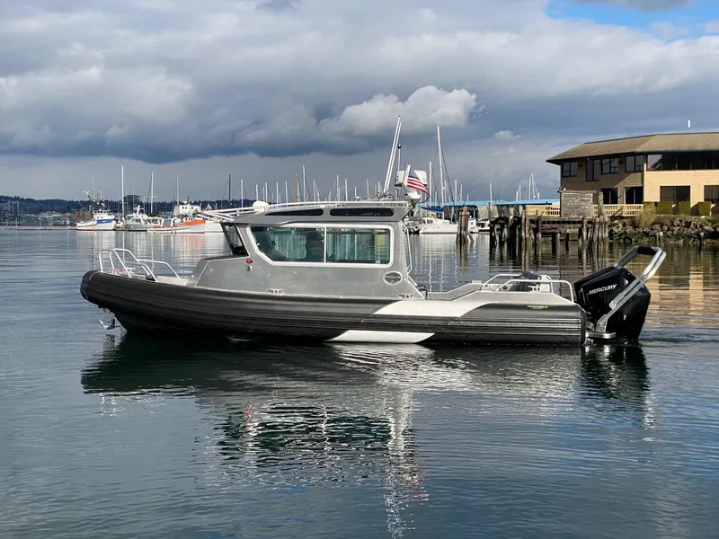 Slide: The Image of 2021 Life Proof 25 Full Cabin boat on calm water near a marina. - 33