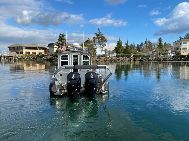 Slide: The Image of 2021 Life Proof 25 Full Cabin boat with dual engines on a calm waterfront. - 36
