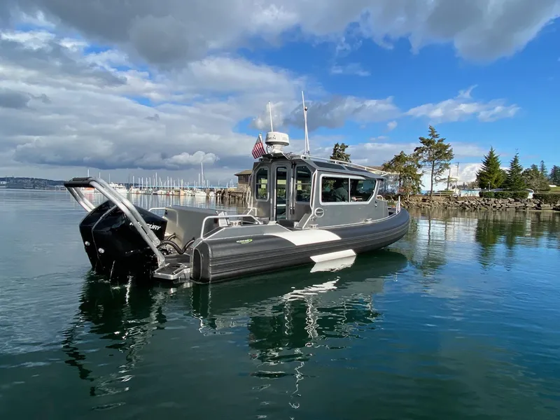 Slide: The Image of 2021 Life Proof 25 Full Cabin boat on calm water under a partly cloudy sky. - 37