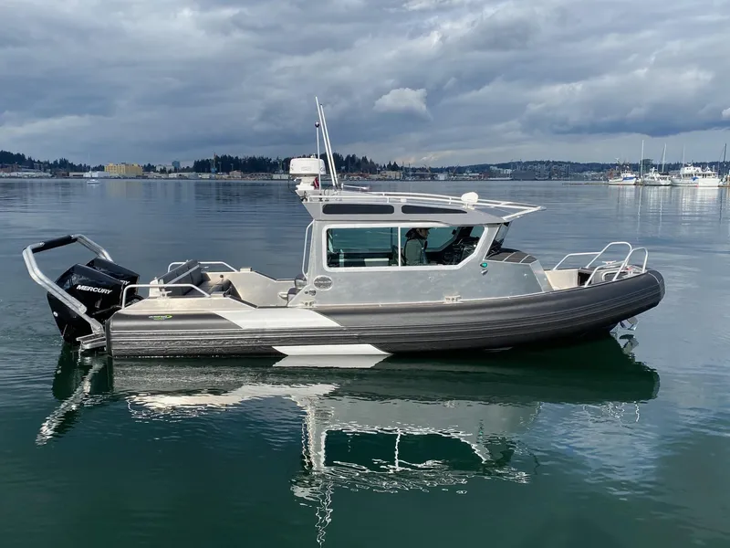 Slide: The Image of 2021 Life Proof 25 Full Cabin boat on calm water under cloudy skies. - 4