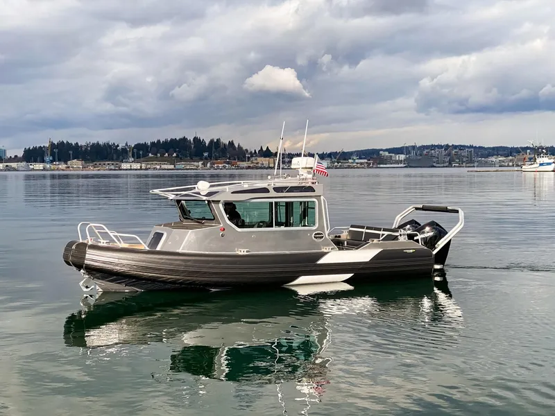 Slide: The Image of 2021 Life Proof 25 Full Cabin boat on calm water under cloudy sky. - 6