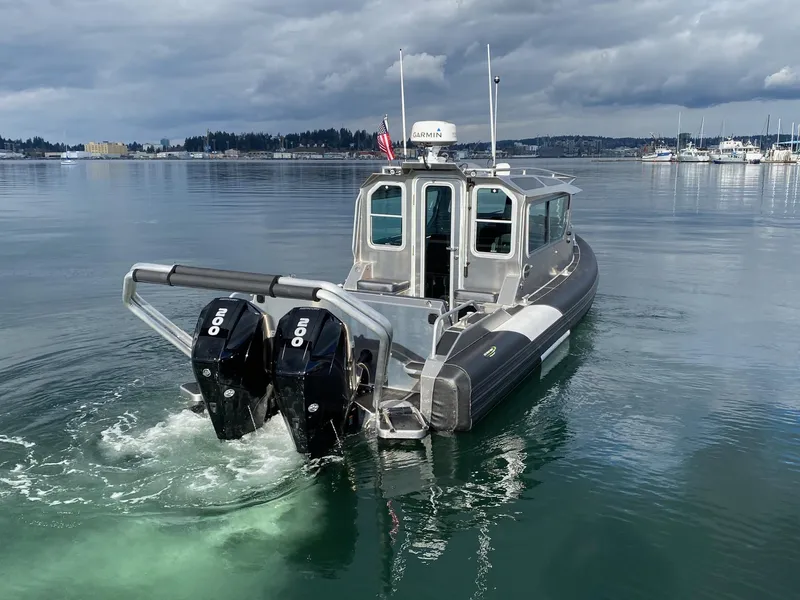 Slide: The Image of 2021 Life Proof 25 Full Cabin boat with dual engines on calm water. - 8