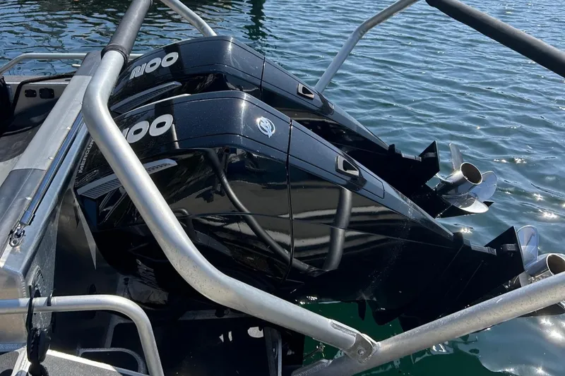 Slide: The Image of Twin outboard motors on a 2021 Life Proof 25 Full Cabin boat in water. - 9