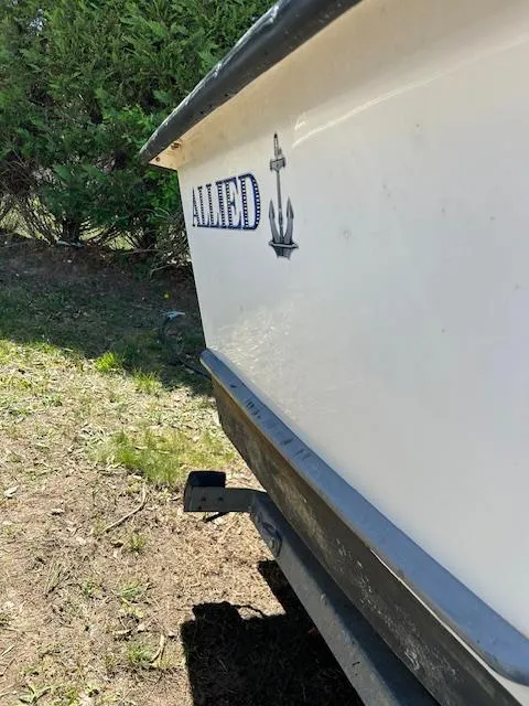 Slide: The Image of 2016 Allied Sportsman boat side view with logo and anchor emblem. - 6