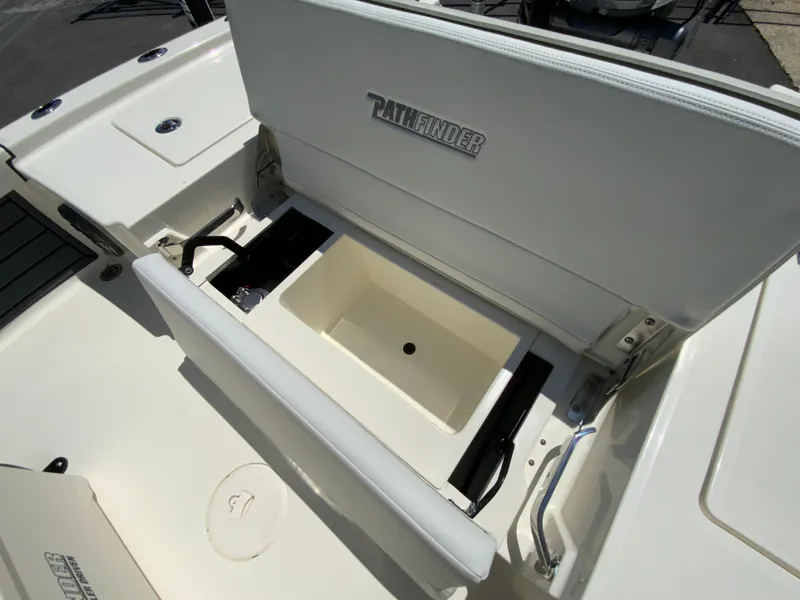 Slide: The Image of 2025 Pathfinder 2200 TRS boat with open storage compartment, showcasing interior design. - 16