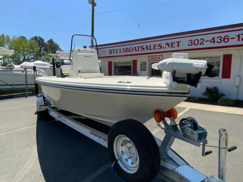Slide: The Image of 2025 Pathfinder 2200 TRS boat on trailer at dealership, sunny day. - 3