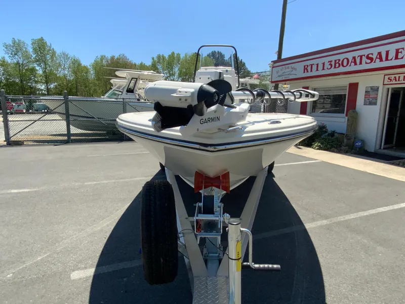 Slide: The Image of 2025 Pathfinder 2200 TRS boat on trailer at dealership, featuring Garmin equipment. - 4