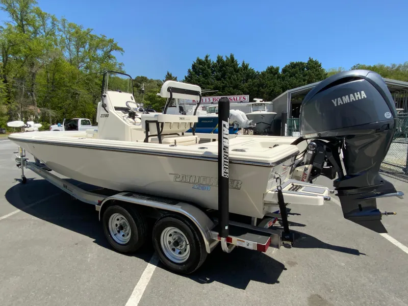 Slide: The Image of 2025 Pathfinder 2200 TRS boat with Yamaha engine on a trailer in a parking lot. - 7
