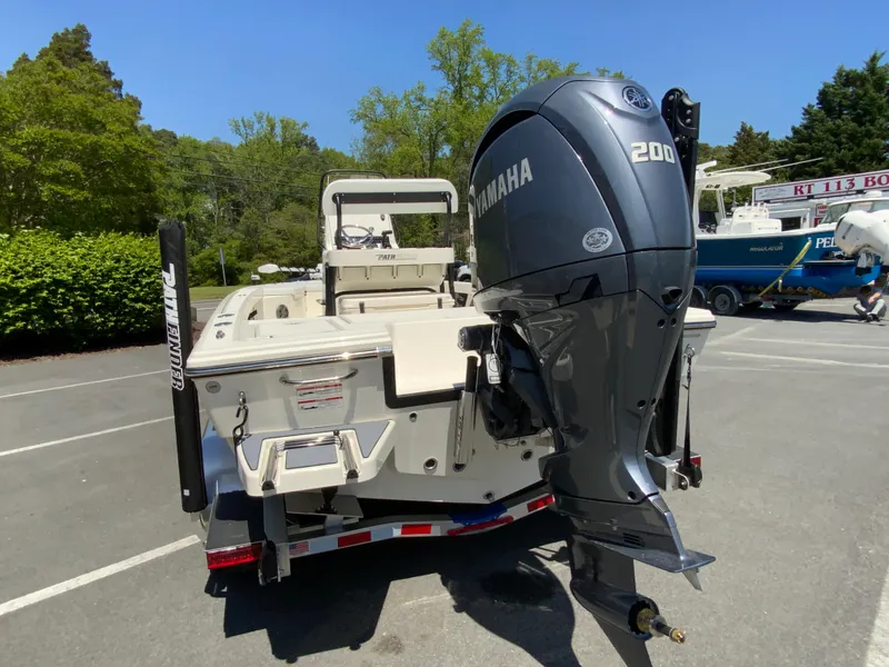 Slide: The Image of 2025 Pathfinder 2200 TRS boat with Yamaha 200 engine, parked outdoors. - 8