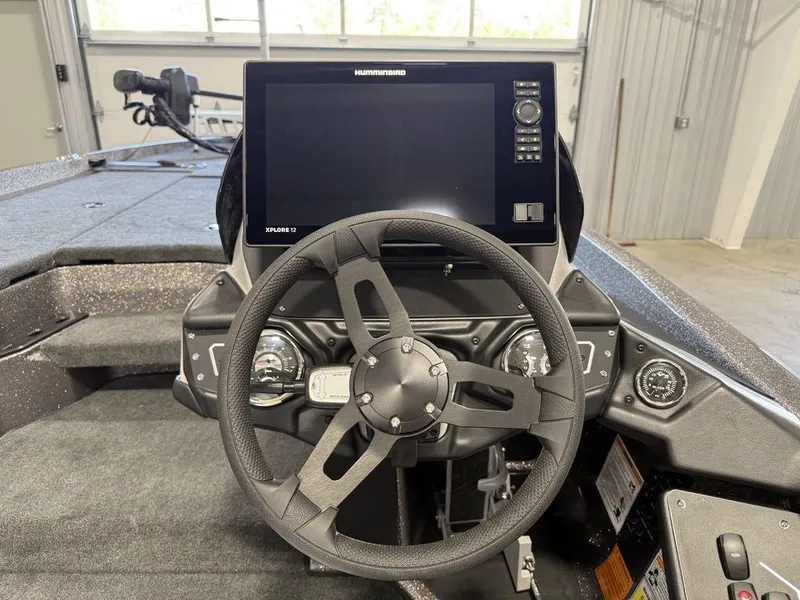 Slide: The Image of 2025 Skeeter ZXR19 boat dashboard with steering wheel and electronic display. - 12