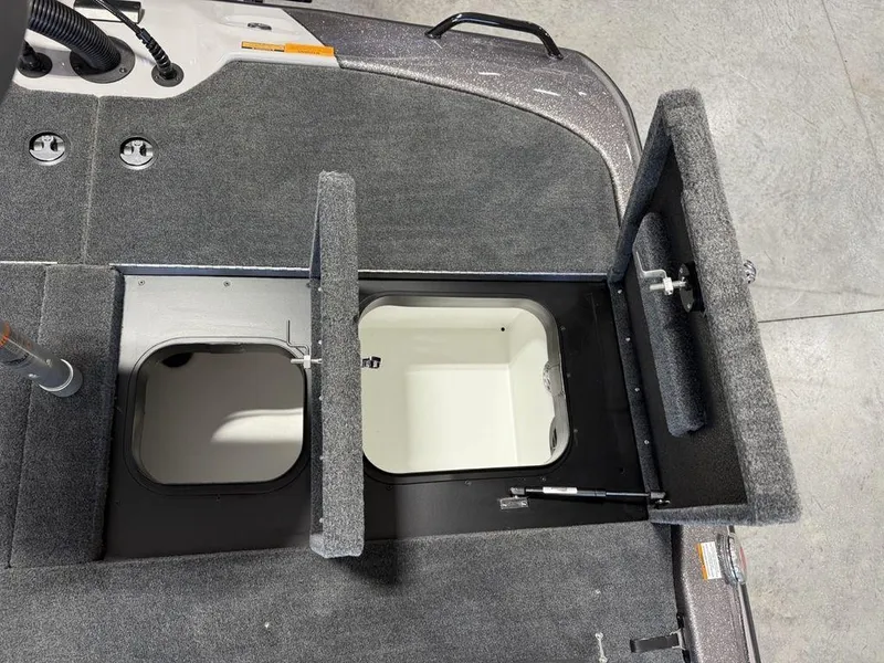 Slide: The Image of 2025 Skeeter ZXR19 boat storage compartments with open hatches, showcasing interior design. - 15