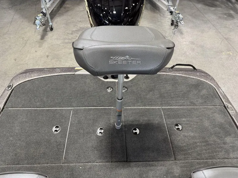 Slide: The Image of 2025 Skeeter ZXR19 boat seat on a carpeted deck, showcasing sleek design. - 17