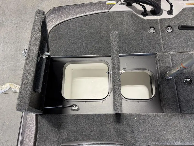 Slide: The Image of 2025 Skeeter ZXR19 boat storage compartments with open hatches, showcasing interior design. - 18