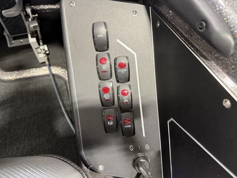Slide: The Image of Control panel of 2025 Skeeter ZXR19 boat with labeled switches and buttons. - 19