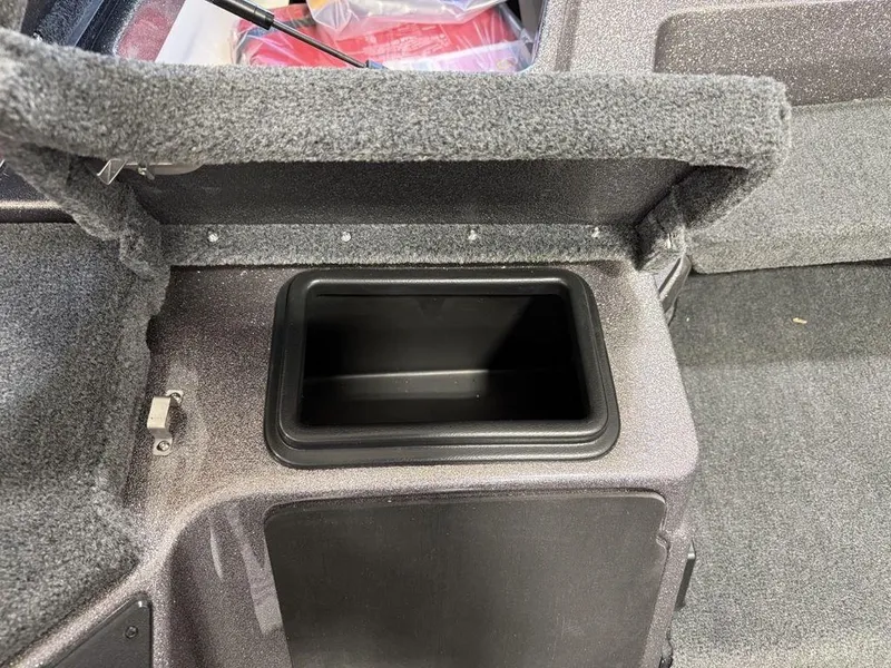 Slide: The Image of 2025 Skeeter ZXR19 boat storage compartment with open lid, showcasing interior space. - 7