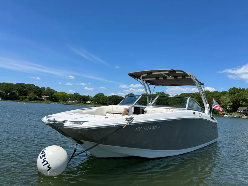 Slide: The Image of 2015 Cobalt 24SD boat anchored on a sunny lake with clear blue skies. - 3
