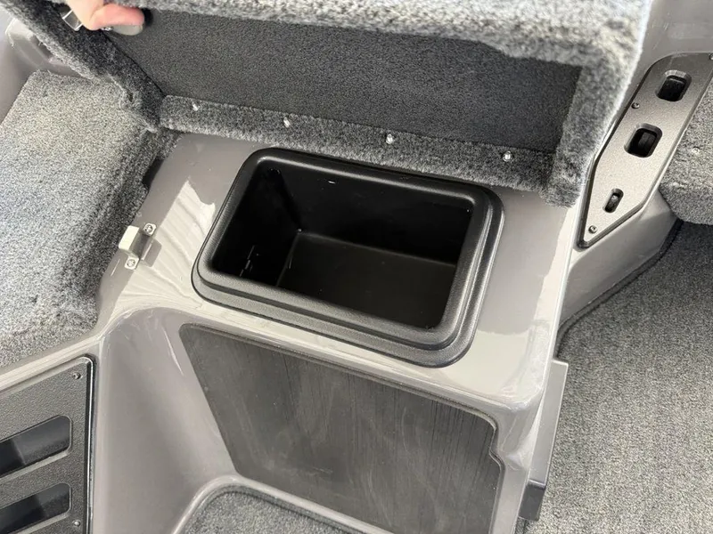 Slide: The Image of Storage compartment in 2025 Skeeter ZXR19 boat, open lid, gray interior. - 11