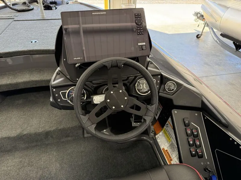 Slide: The Image of 2025 Skeeter ZXR19 boat dashboard with steering wheel and electronic display. - 16