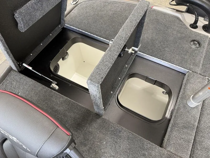 Slide: The Image of Skeeter ZXR19 2025 boat storage compartments with open hatches, showcasing interior space. - 18