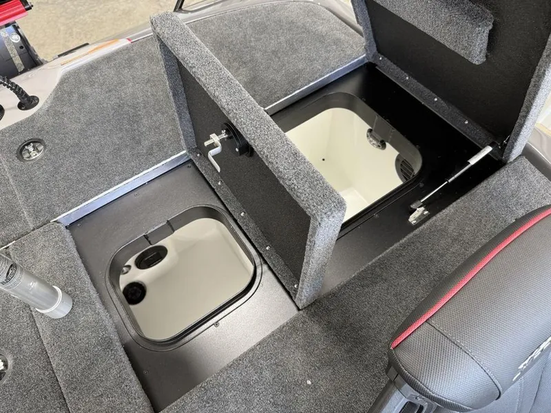 Slide: The Image of 2025 Skeeter ZXR19 boat storage compartments with open hatches and carpeted interior. - 19