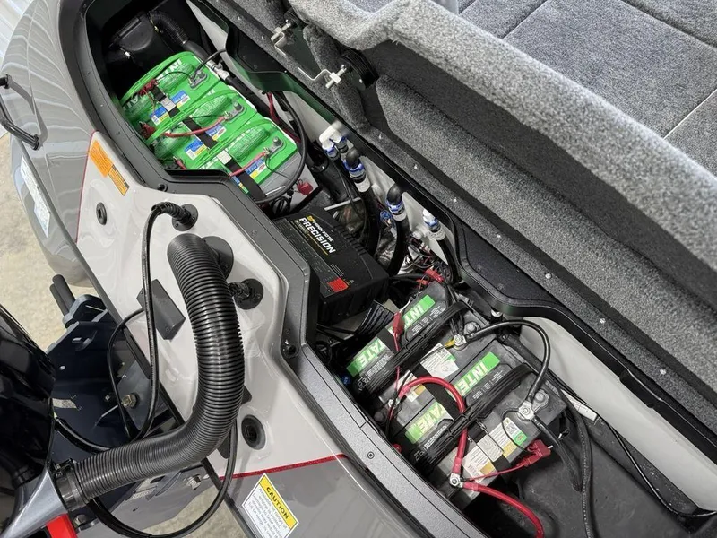 Slide: The Image of 2025 Skeeter ZXR19 boat battery compartment with multiple batteries and wiring. - 20