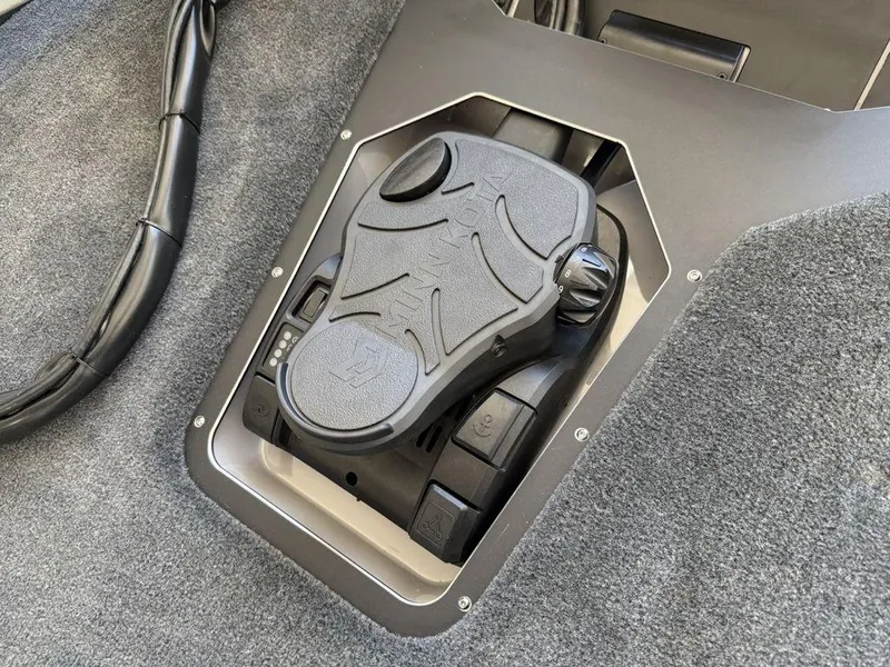 Slide: The Image of 2025 Skeeter ZXR19 boat foot pedal control on carpeted floor. - 6