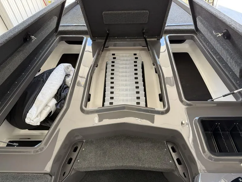 Slide: The Image of 2025 Skeeter ZXR19 boat storage compartments with open hatches and organized interior layout. - 9