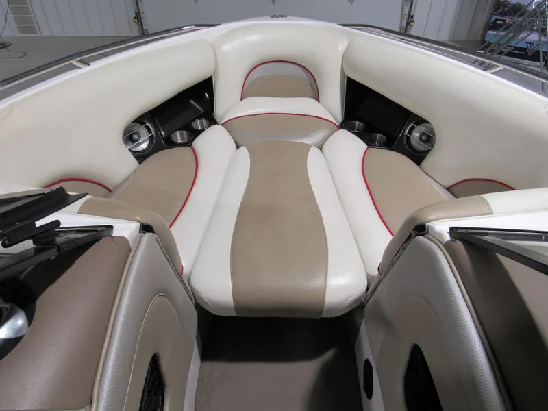 Slide: The Image of 2007 Malibu Sunscape 247 LSV boat interior with beige and white seating. - 12