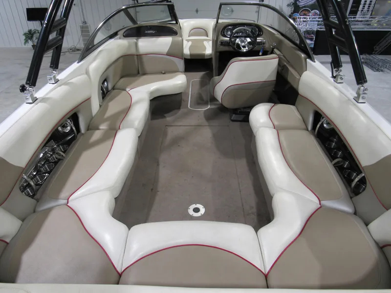 Slide: The Image of 2007 Malibu Sunscape 247 LSV boat interior with beige and white seating. - 4