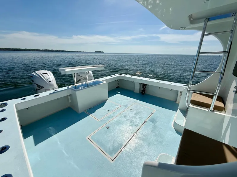 Slide: The Image of 2023 Millennium Marine NuWave 37 boat deck with ocean view and ladder. - 12