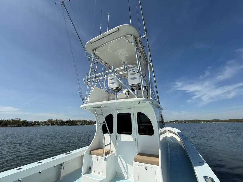 Slide: The Image of 2023 Millennium Marine NuWave 37 boat on calm water under clear blue sky. - 13