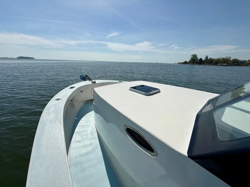 Slide: The Image of 2023 Millennium Marine NuWave 37 boat on calm water under clear sky. - 17