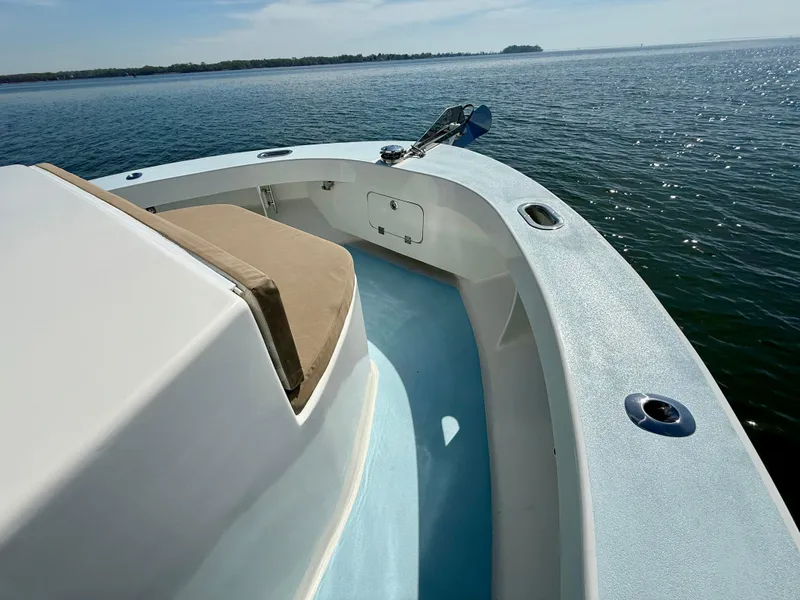 Slide: The Image of 2023 Millennium Marine NuWave 37 boat on calm water, showcasing sleek deck design. - 20