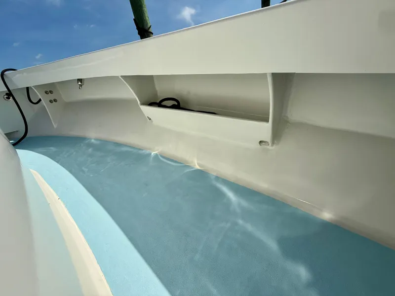 Slide: The Image of 2023 Millennium Marine NuWave 37 boat interior with sleek white and blue design. - 22