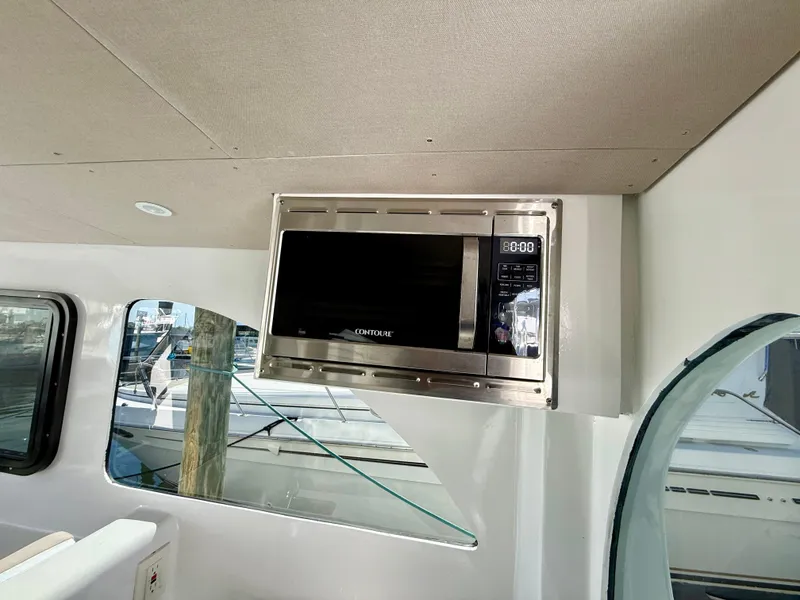 Slide: The Image of Built-in microwave on 2023 Millennium Marine NuWave 37 boat interior. - 29