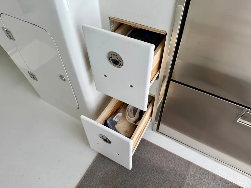 Slide: The Image of Storage drawers on a 2023 Millennium Marine NuWave 37 boat interior. - 31