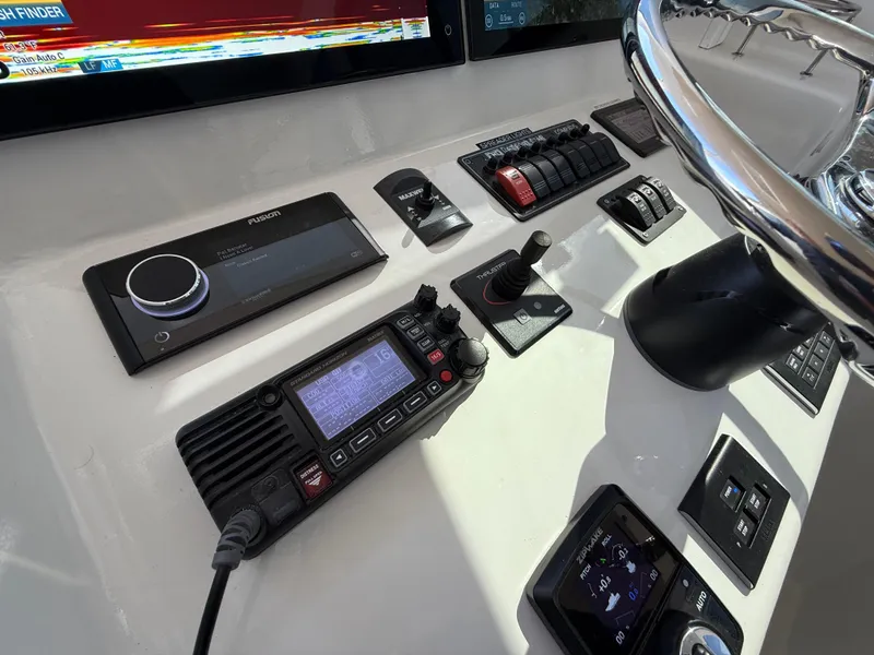 Slide: The Image of Control panel of 2023 Millennium Marine NuWave 37 with navigation and communication equipment. - 39