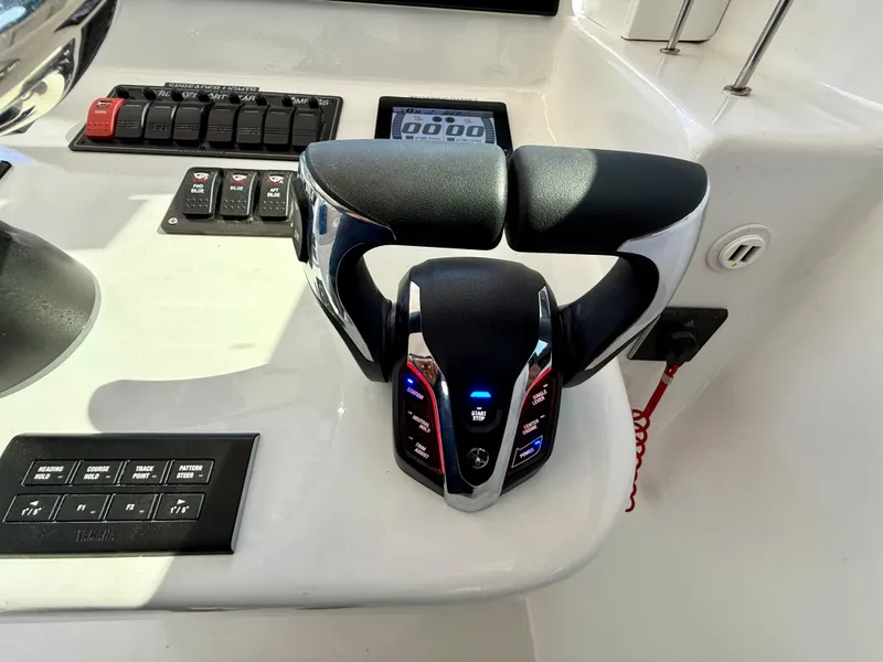 Slide: The Image of Control panel of 2023 Millennium Marine NuWave 37 boat with throttle and switches. - 41
