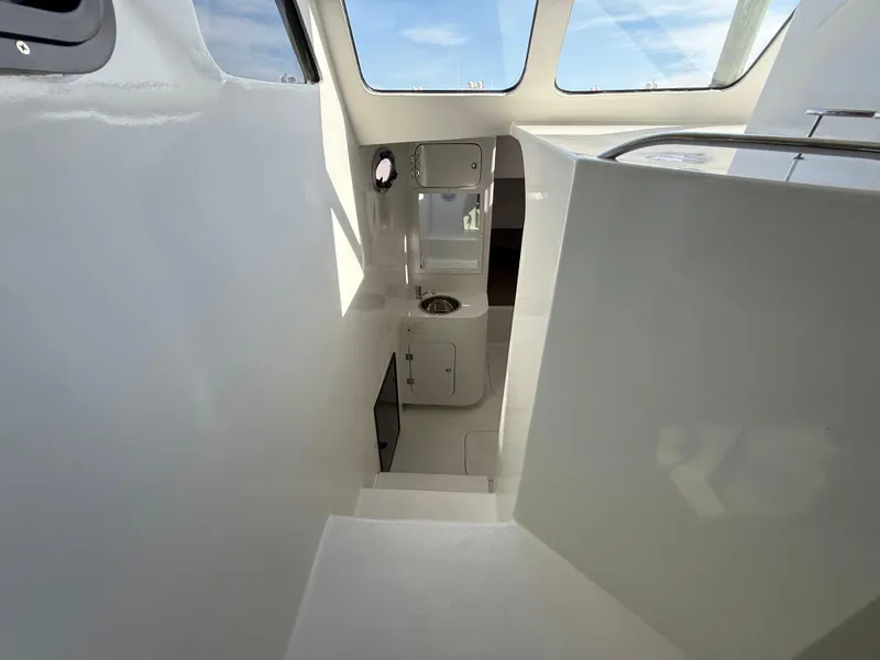 Slide: The Image of Interior view of 2023 Millennium Marine NuWave 37 boat, featuring sleek white design and modern amenities. - 43