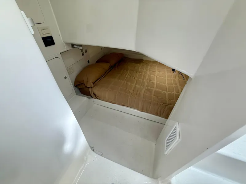 Slide: The Image of 2023 Millennium Marine NuWave 37 cabin interior with a cozy bed and modern design. - 46