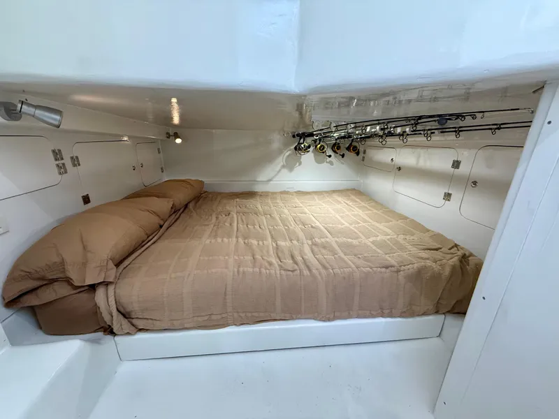 Slide: The Image of Cozy cabin interior of 2023 Millennium Marine NuWave 37 with a neatly made bed. - 47