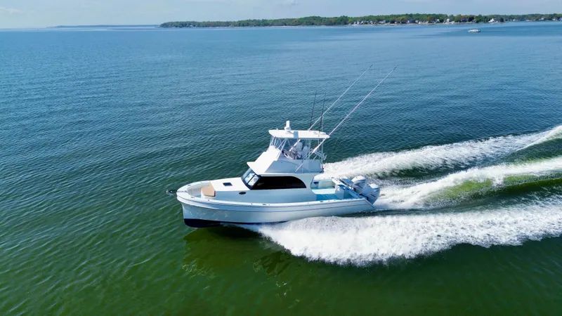 Slide: The Image of 2023 Millennium Marine NuWave 37 cruising on open water, showcasing sleek design and performance. - 5