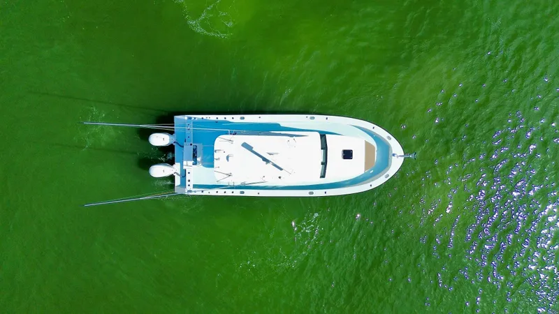 Slide: The Image of Aerial view of 2023 Millennium Marine NuWave 37 boat on vibrant green water. - 8