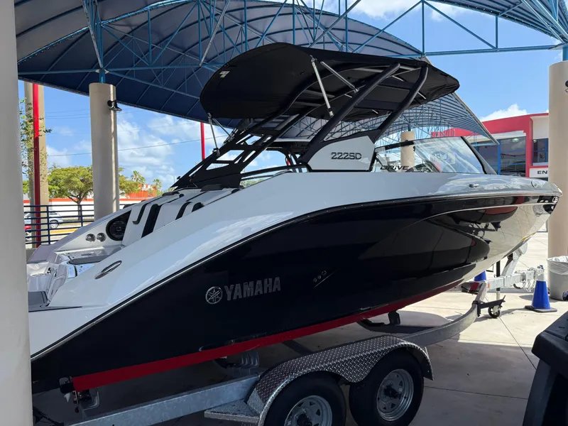 Slide: The Image of 2025 Yamaha Boats 222SD on trailer under canopy, showcasing sleek design and modern features. - 2