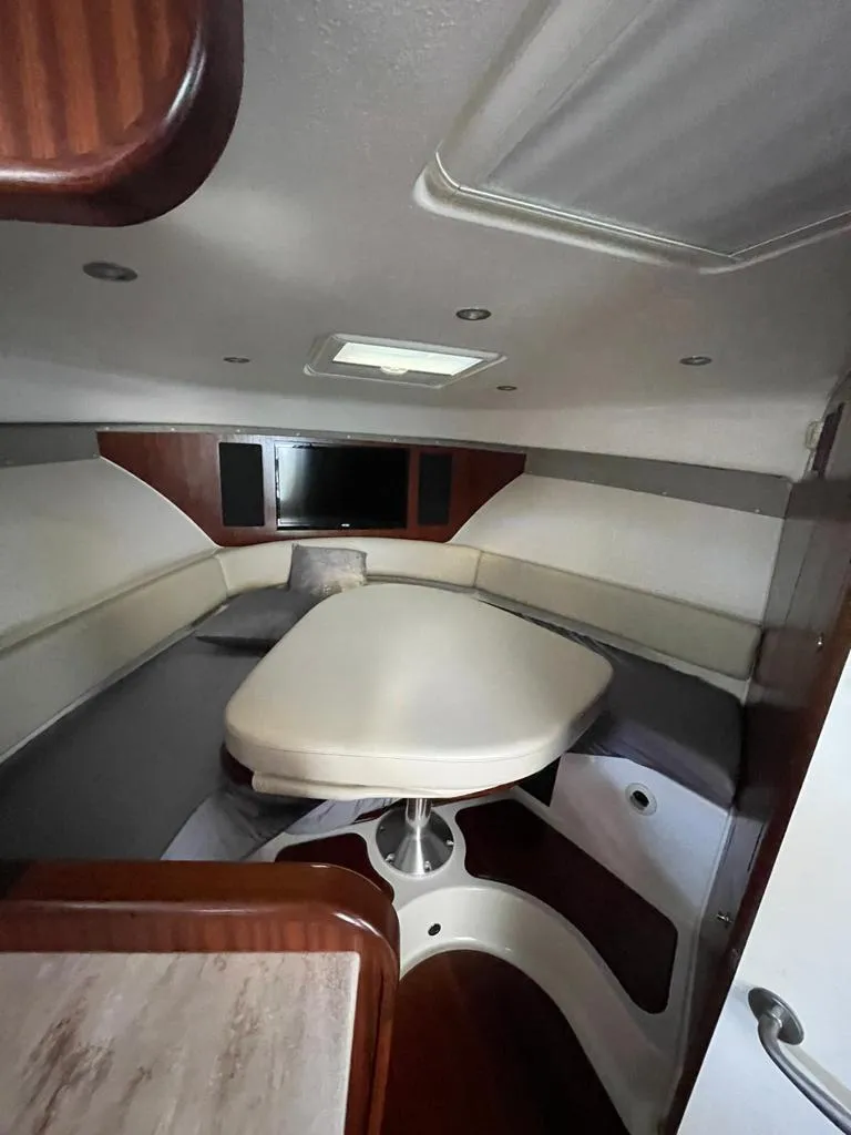 Slide: The Image of 2019 Pursuit OS 385 Offshore cabin interior with seating and table. - 28