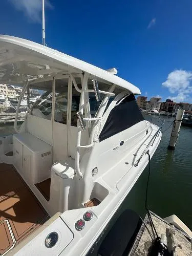 Slide: The Image of 2019 Pursuit OS 385 Offshore boat docked in a sunny marina. - 5