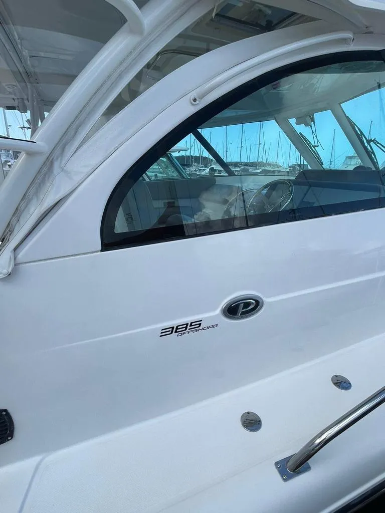 Slide: The Image of 2019 Pursuit OS 385 Offshore boat, sleek design, docked at marina. - 6